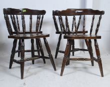 A set of 4 windsor beech wood dining chairs raised on turned legs with saddle seat having spindle