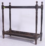 A Victorian oak stick stand - umbrella stand having sectioned body with trays to base having finial