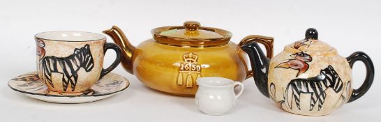 A Boston Tea party anniversary teapot by Davison Newman and co along with a teapot and cup and