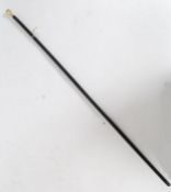 An early 20th century ebonised horn ? yellow metal promenade cane,