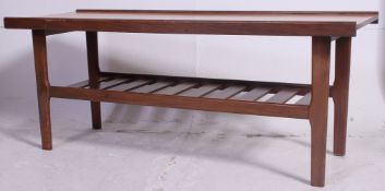 A 1960's coffee table, on turned legs with slatted tier beneath.