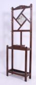 An Edwardian mahogany hall stand having mirror upright with hooks and a central glove box over drip