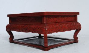 A late 19th / early 20th century Chinese red laquered hardwood low tea / opium table  having a