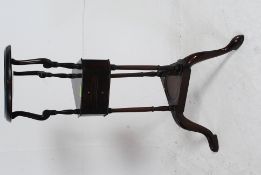 An antique style mahogany plant stand / torchere being raised on turned legs with central drawer