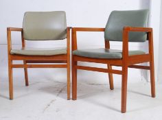 A pair of M&M retro squared tubular office chairs, each with vinyl upholstery.