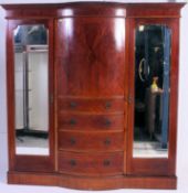 An Edwardian mahogany inlaid bow front triple wardrobe armoire compactum.