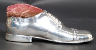 A silver hallmarked pin cushion in the form of a gentlemans large shoe. Chester hallmarks for S.