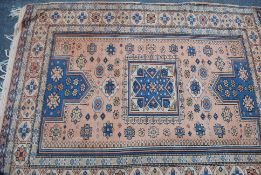 An early 20th century Persian rug having blue ground with red border and central medallions