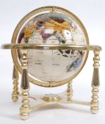A Lapis Lazuli inlaid brass desk top revolving globe.