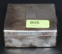 A silver hallmarked table top cigarette case with plain cartouche, wood lined interior.