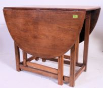 A good Ercol beech and elm drop leaf dining table raised on squared legs united by low stretchers.