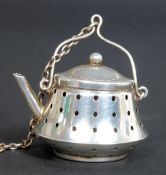 A sterling silver ( marked Sterling to base ) tea infuser being in the form of a teapot,