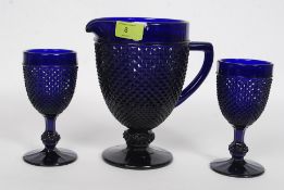 A Bristol Blue? pressed glass serving jug having a geometric pattern along with two matching