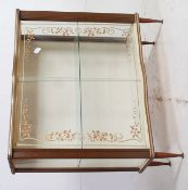 A 1950's glass framed display cabinet, with guilt decoration to the glass on tapered legs.