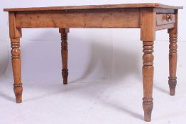 A Victorian country pine dining table raised on turned legs with fitted frieze having planked top