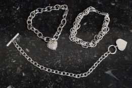 A collection of three silver white metal items - a 925 chain linked bracelet,