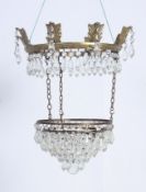 A vintage mid 20th century brass and cut glass double drop empire chandelier having cut glass