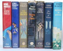 A collection of twelve Dennis Wheatley first edition hardback book novels with dust jackets.