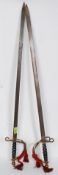 A pair of decorative early to mid-century brass and steel cavalry swords,