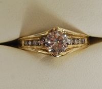A 14ct yellow gold diamond ring, with central stone of 1ct (exact weight) with diamond shoulders.