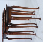 An antique style mahogany and burr walnut nest of tables having oval graduating tops to each raised