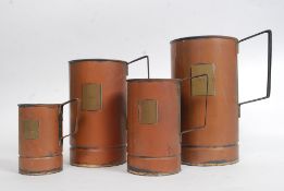 A collection of 20th century copper grain measures