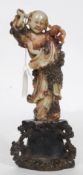 Chinese soapstone figurine being well detailed of a scholar being raised on black ebonised plinth