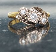 An 18ct gold vintage diamond ring having 3 inset stones on claw mounts. The diamonds approx 20pnts.