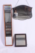 A collection of three mirrors , one being teak surrounded, oak framed and another.