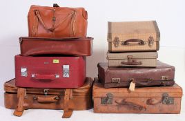 A collection of vintage suitcases dating from the 20th century to include various shapes and sizes.
