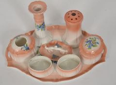 A good early 20th century continental ceramic dressing table set in pink with floral sprays