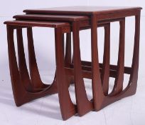 A retro 1970's G-Plan Kelso Nest of table in teak raised on squared supports having graduating tops