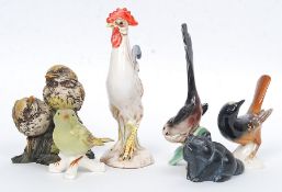 A collection of Goebels West German ceramic bird figurines together with others