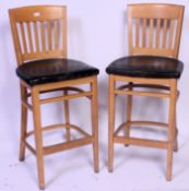A set - pair of 2 20th century upholstered chunky beechwood & black leather bar stools - cafe high