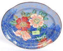 A Royal Doulton painted Aenome D 6227 dish on a blue wash background,