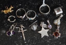A collection of silver to include rings,  necklace pendants, crucifix, charms etc. Total weight 32.