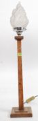 A stunning Art Deco oak table lamp of simple form standing on a square base,