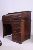 A 1920's solid oak roll top tambour desk. Roll top with appointed interior over pedestal of drawers.