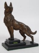 A vintage 1930's Art Deco spelter and marble figurine of an Alsatian dog raised on marble stepped