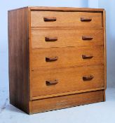 A 1950's Ernest Gomme - G-Plan oak straight four chest of drawers having pull original handles over