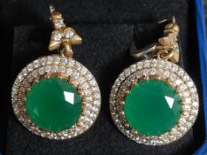 A pair of large ladies cz and real emerald earrings