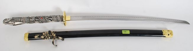 A replica ' Highlander ' sword having faux bone carved handle in the form of a dragon complete with