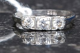 An 18ct white gold 3 stone diamond ring. The 3 central stones approx 20pnts in total.