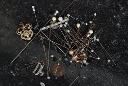 A collection of vintage hat pins dating to the 19th and 20th century to include decorative examples.
