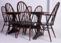 An Ercol 1970's Windor pattern refectory dining table together with 6 dining chairs including 2