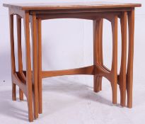 A 1970's Danish style teak wood nest of graduating tables being raised on angular legs united by