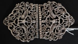 A vintage hallmarked silver nurses belt buckle, decorated with a bird within foliates.