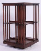 An antique Edwardian style mahogany inlaid revolving bookcase cabinet having castors to base with