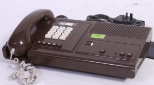 A 1970's retro BT telephone answer machine home phone in brown with push buttons etc.