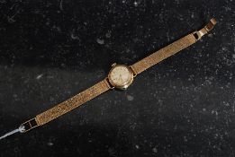 A ladies 9ct gold Omege cocktail watch set over original 9ct gold bracelet.